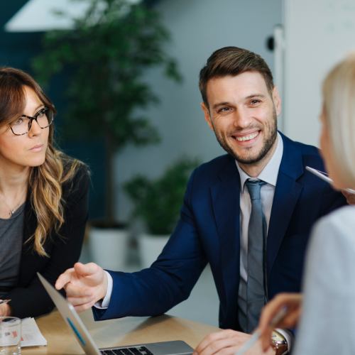 Team meeting around a laptop